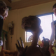 A little girl shrieks in horror at a shriveled, brown alien with a telescopic neck.